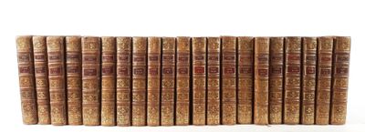 a stack of old books sitting on top of each other on a white surface