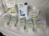 several bottles of hand sanitizer are lined up on a table