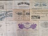 several old french bank notes on a wooden table