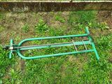 a green hose laying on the ground next to a fence