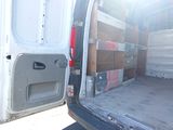 the back of a white van with its door open and a lot of boxes in the back