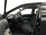 the interior of a car with the door open and the driver ' s seat down
