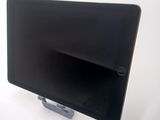 a tablet computer sitting on a stand on a white surface