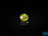 a yellow and green diamond on a black surface