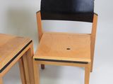 two chairs that are next to each other on a white background