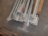 a pile of metal rods and a piece of wood on the floor