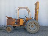 a small tractor that is parked in front of a building