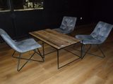 three chairs and a table in a dark room