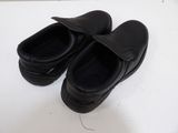a pair of black shoes that are on a table