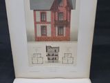 un livre ouvert sur lequel figure l'image d'une maison rouge