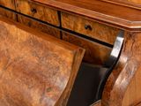 a wooden dresser with a drawer on top of it