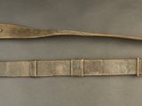 pair of antique brass buckles on a gray background
