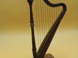 an image of a small wooden harp on a stand