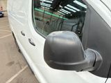 a white van parked in a parking lot next to a building