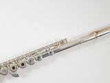 a flute that is sitting on a white surface