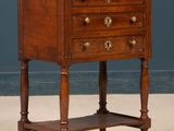 an old wooden table with a drawer on top of it
