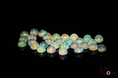white fire oplite beads on a black background