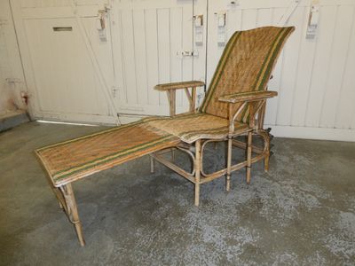 a wicker chaise lounger in a garage
