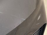 a close up of a car ' s front grill with scratches on it