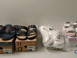 many pairs of shoes that are sitting on a table