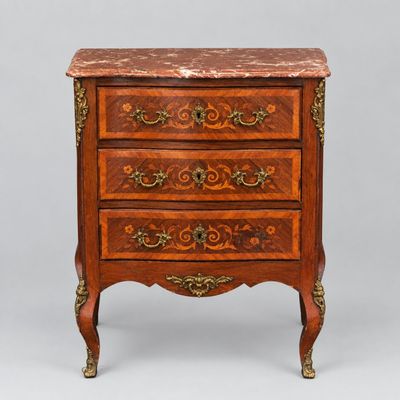 an antique chest of drawers with marble top