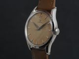 a close up of a watch with a brown leather strap