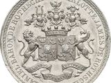 a close up of a silver coin with a coat of arms on it