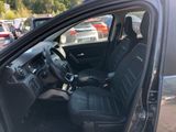 the interior of a car with black seats in a parking lot