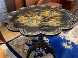 a table with a flower design on it on a rug