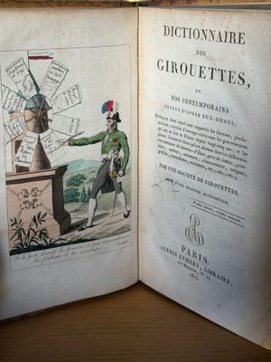 un livre ouvert sur lequel figure l'image d'un homme et d'un moulin à vent