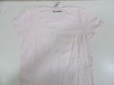 pink t - shirt on a hanger on a white table