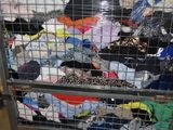 a metal cart with a bunch of clothes on it