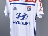 the shirt is white and blue with a red and white design