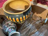 a box full of empty glasses and a vase