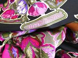 a close up of a colorful scarf with a name on it