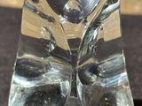 a glass sculpture of a cat with a bow tie on it