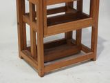 a small wooden table with two shelves on it