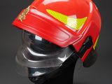 a close up of a red fireman ' s helmet on a mannequin head