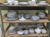 a lot of plates and bowls on a shelf
