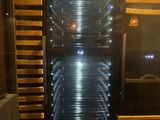 a stainless steel oven that has many racks of food inside of it
