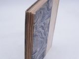an open book sitting on top of a white table covered in blue marble