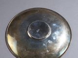 a silver plate with a hole in the middle of it