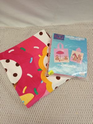 a close up of a blanket and a book on a bed