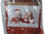 the baby is wearing a santa outfit and a santa hat