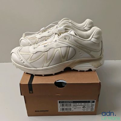 the white sneakers are sitting on top of a box on a table