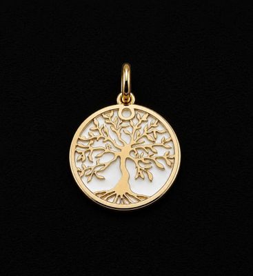 a gold plated tree of life pendant on a black background