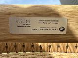 a label on the back of a chair that is made of wood