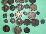 some of the old coins are on a green surface