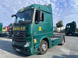 un camion vert garé sur un parking