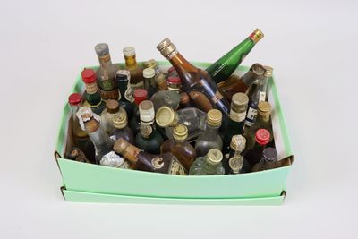 many bottles of alcohol in a box on the table